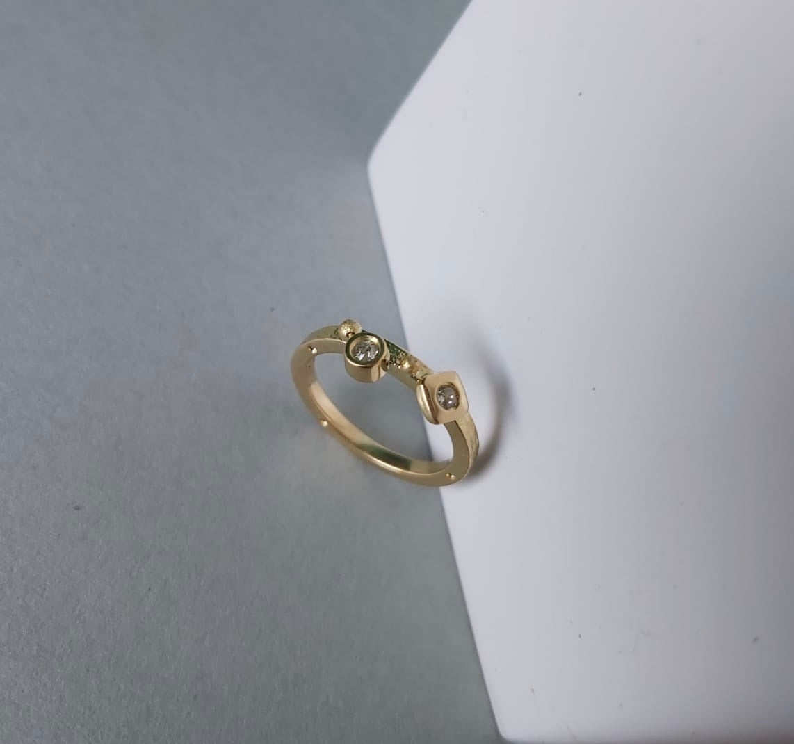 Anne's modern wedding yellow gold and diamonds ring designed by Bold Lines Jewellery shown on a white and grey background