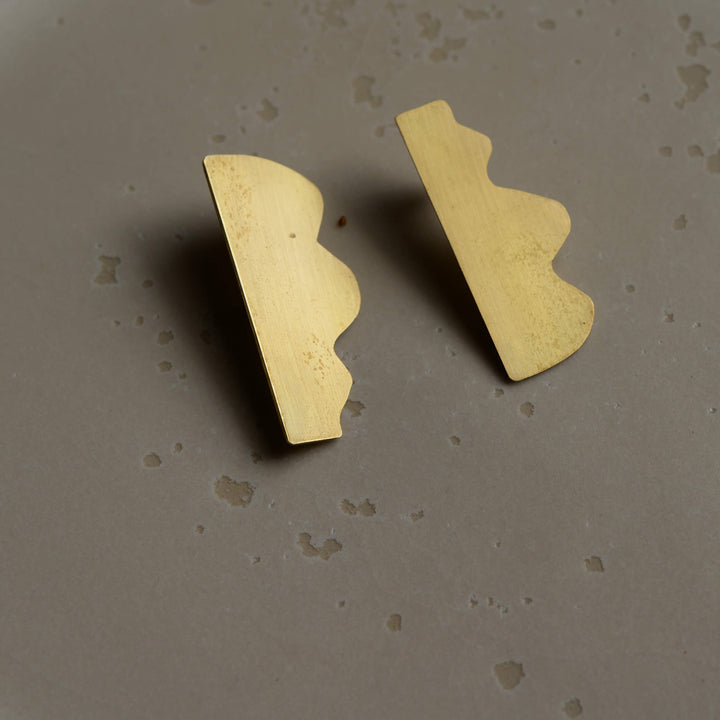 Abstract stud Dream I earrings by Bold Lines Jewellery shown on a ceramic plate.