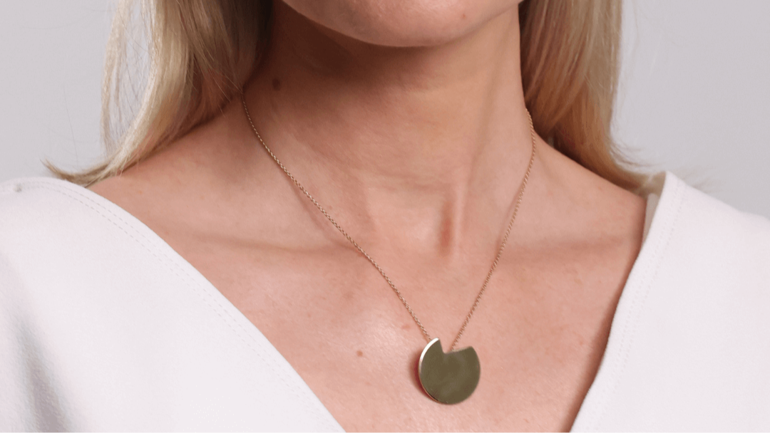 The Bold Lines Jewellery Balance gold minimal necklace worn on a model with a white top