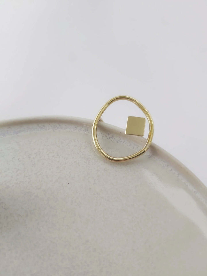 Brass adjustable ring with organic and geometric design.