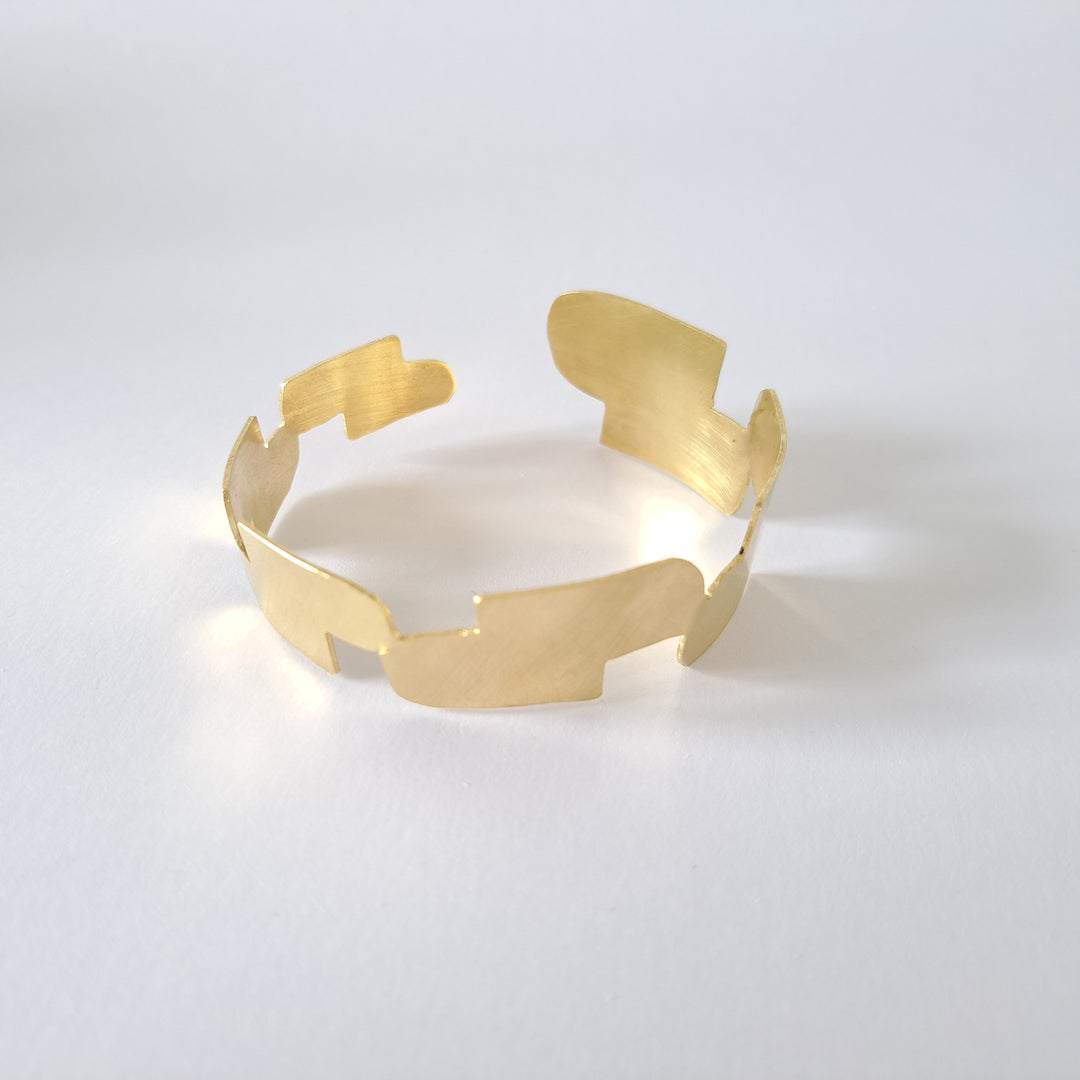 A gold bangle in a white surface.