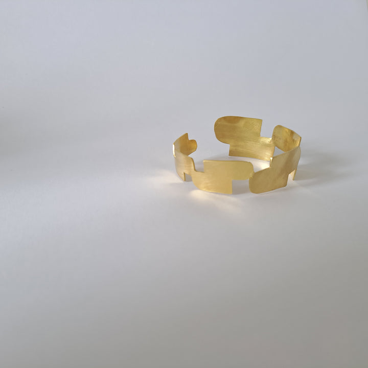 A gold bangle in a white surface.