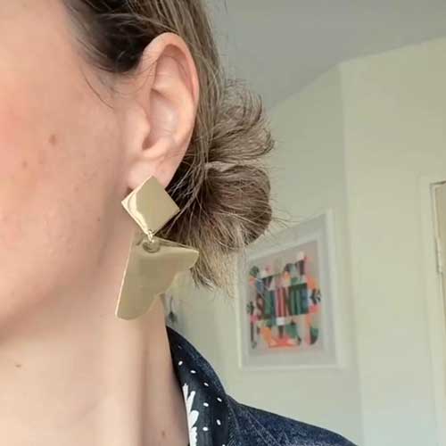Bold Lines Jewellery Dream II earrings worn on a woman's ear.