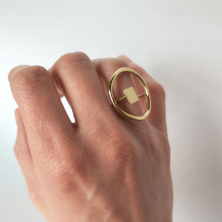 The Imperfection geometric ring by Bold Balance is shown on a hand worn on the ring finger.