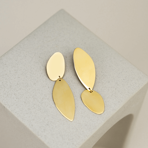  Fluidity earrings designed by Bold Lines Jewellery shown on a geometric stone display