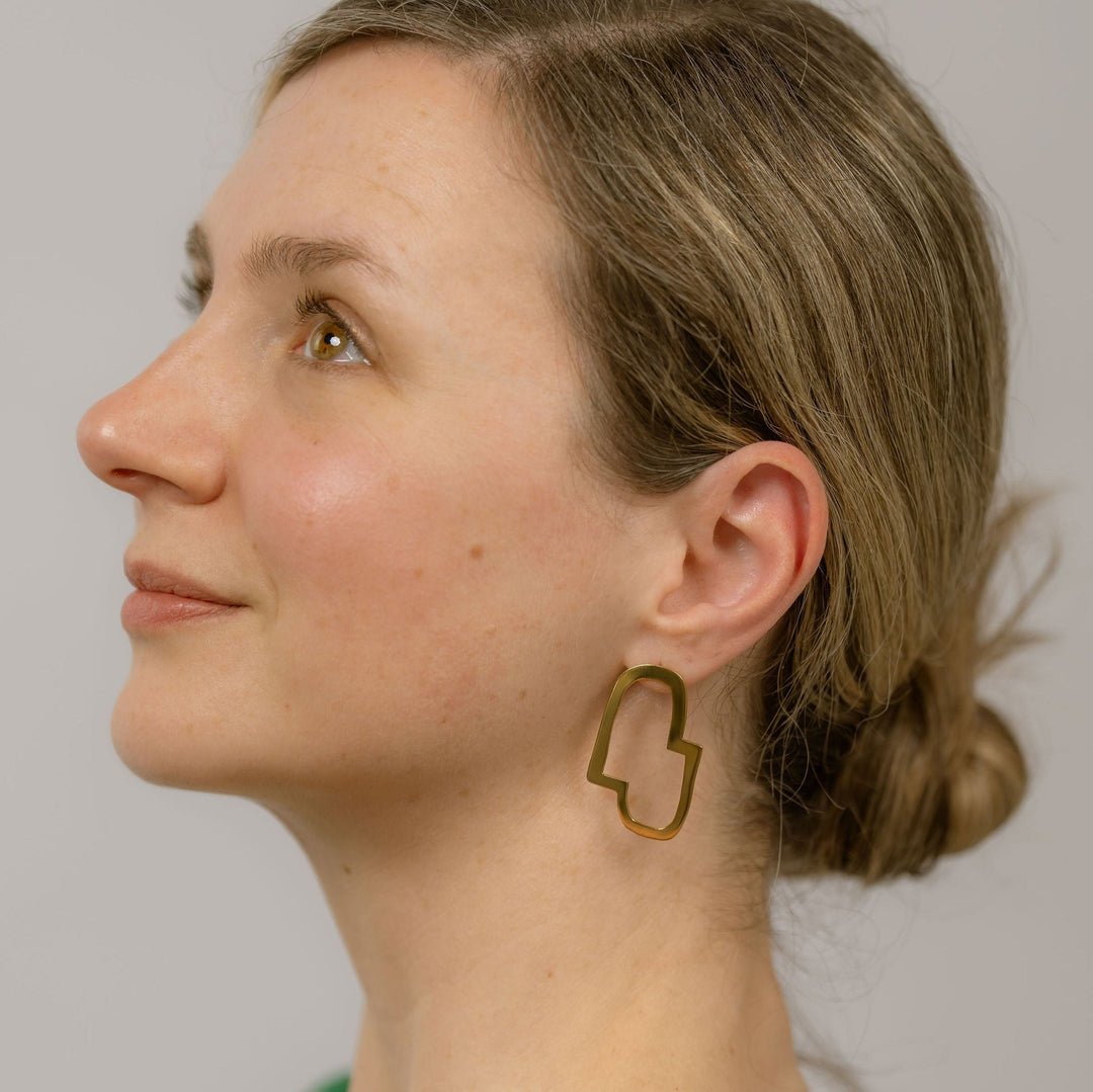 Headshot of the Connection II elegant earrings worn on a model