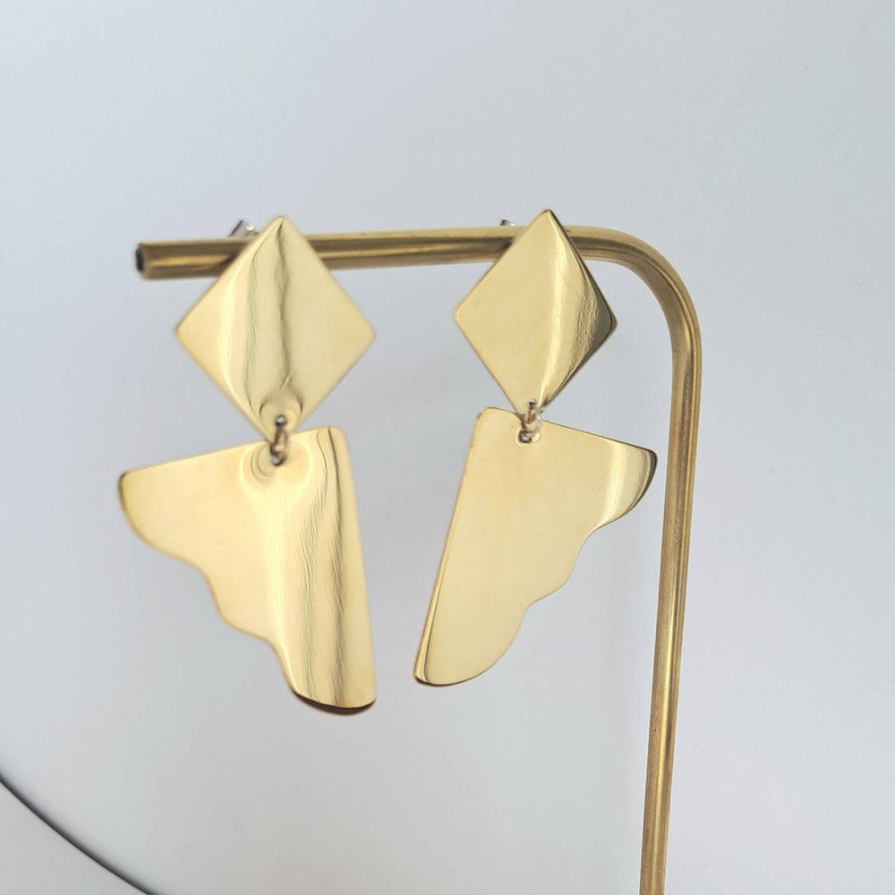Bold Lines Jewellery Dream II earrings hanging on a brass jewellery display hanger.