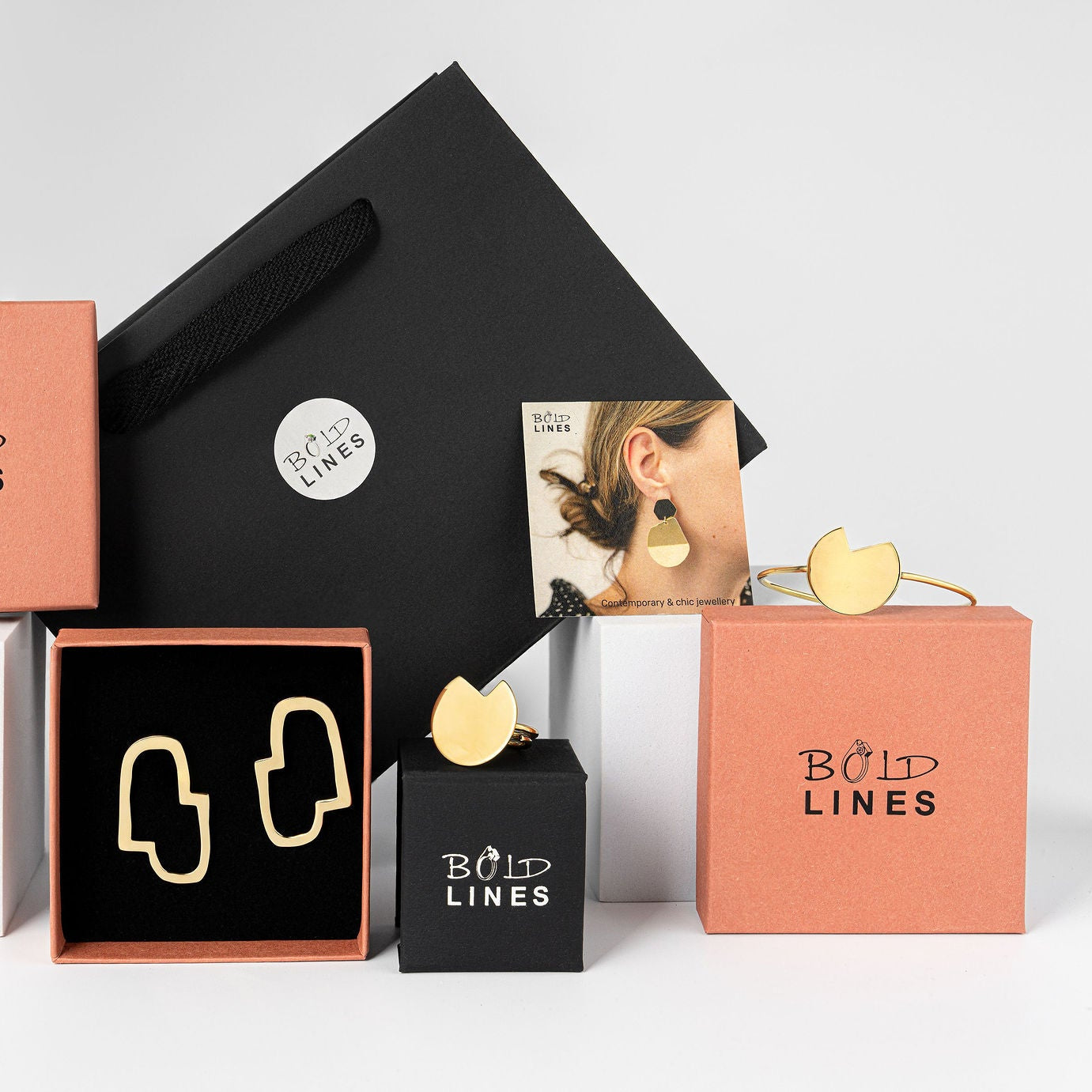 Collection of 'Bold Lines' jewelry boxes and packaging on a light gray background