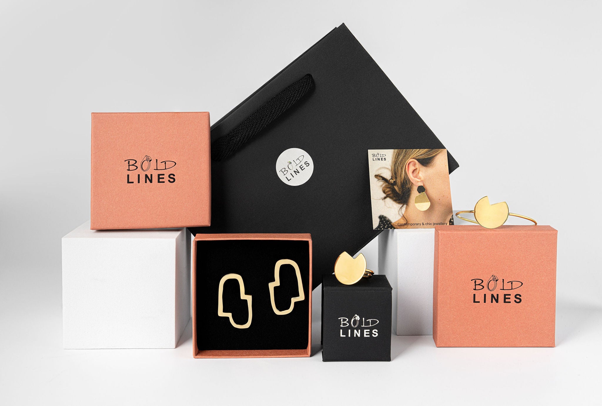 Collection of 'Bold Lines' jewelry boxes and packaging on a light gray background
