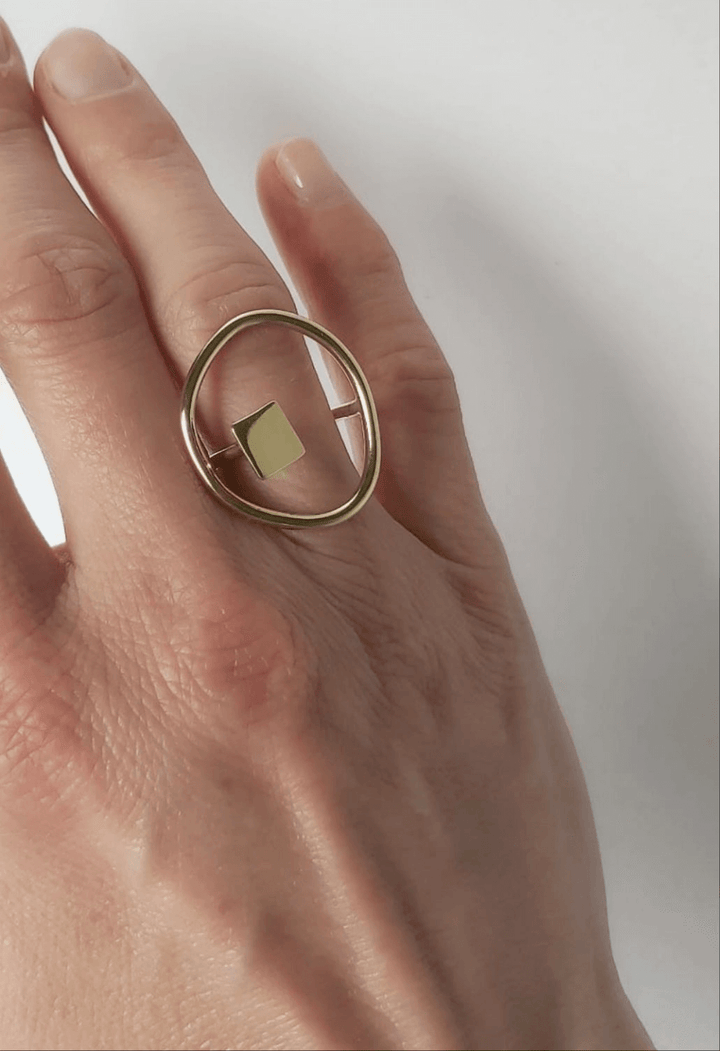 Brass adjustable ring with organic and geometric design.