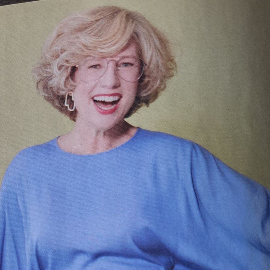 Person wearing a blue outfit with a plain background