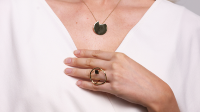 Photo of a mum wearing Bold Lines Connection earrings with balance necklace and |Imperfection earrings.