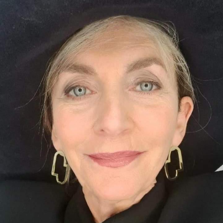 Stylist Cathy O'Connor wearing the Connection II earrings with a big black hat.