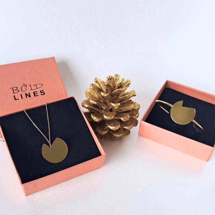 The Balance bold lines jewellery necklace and bracelet shown in their terracotta box