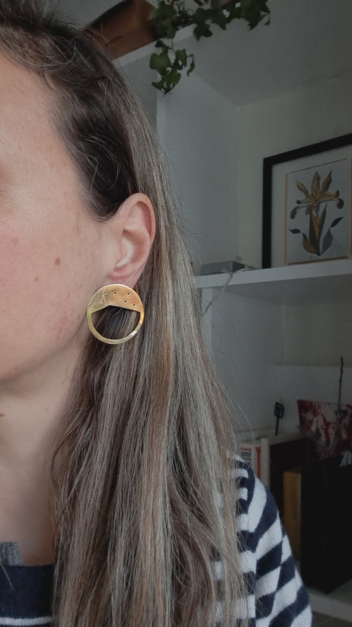 A video of the Galaxy earrings in a high polish 18ct gold finish on a model.