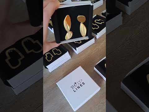 Video showing the elegant asymmetrical gold Fluidity earrings in their box, designed and handmade by Bold Lines jewellery in Kildare Ireland 