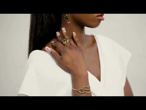 Video of a black woman wearing a bold Lines Jewellery Andree gold  ring with the Eileen gold geometric bracelet paired with a modern white top