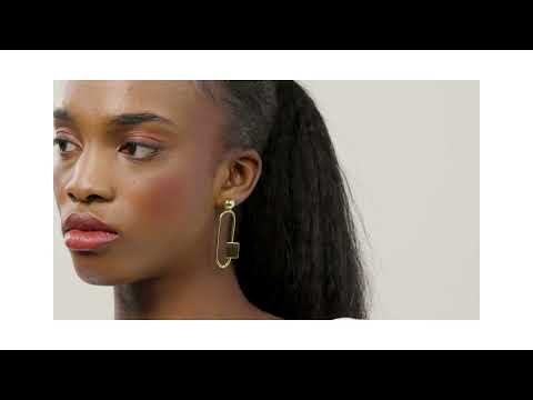 A woman wearring the Bold lines Jewellery gold geometrical earrings 