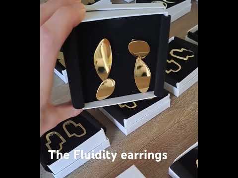 A video showing the elegant asymmetrical gold Fluidity earrings in their box, designed and handmade by Bold Lines Jewellery in Kildare, Ireland.
