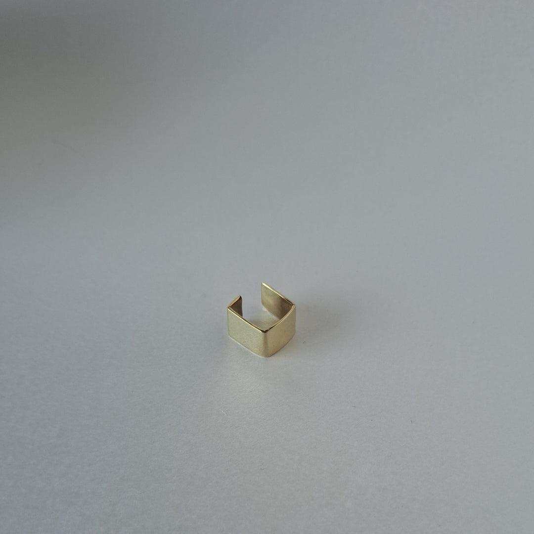 Gold ring on a light gray background