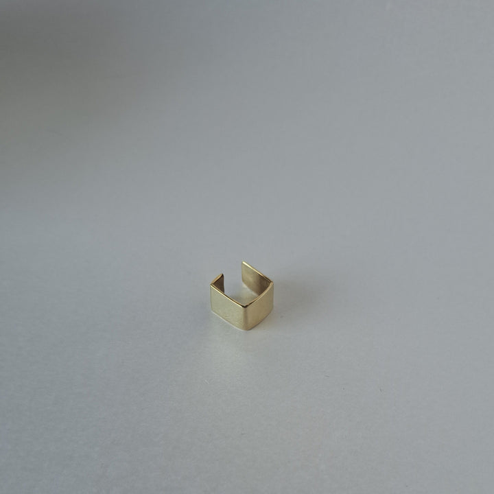 Gold ring on a light gray background