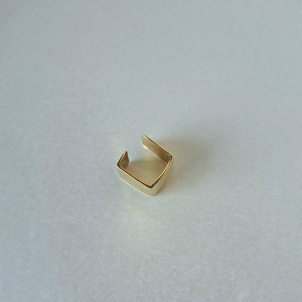 Gold ring on a textured white surface