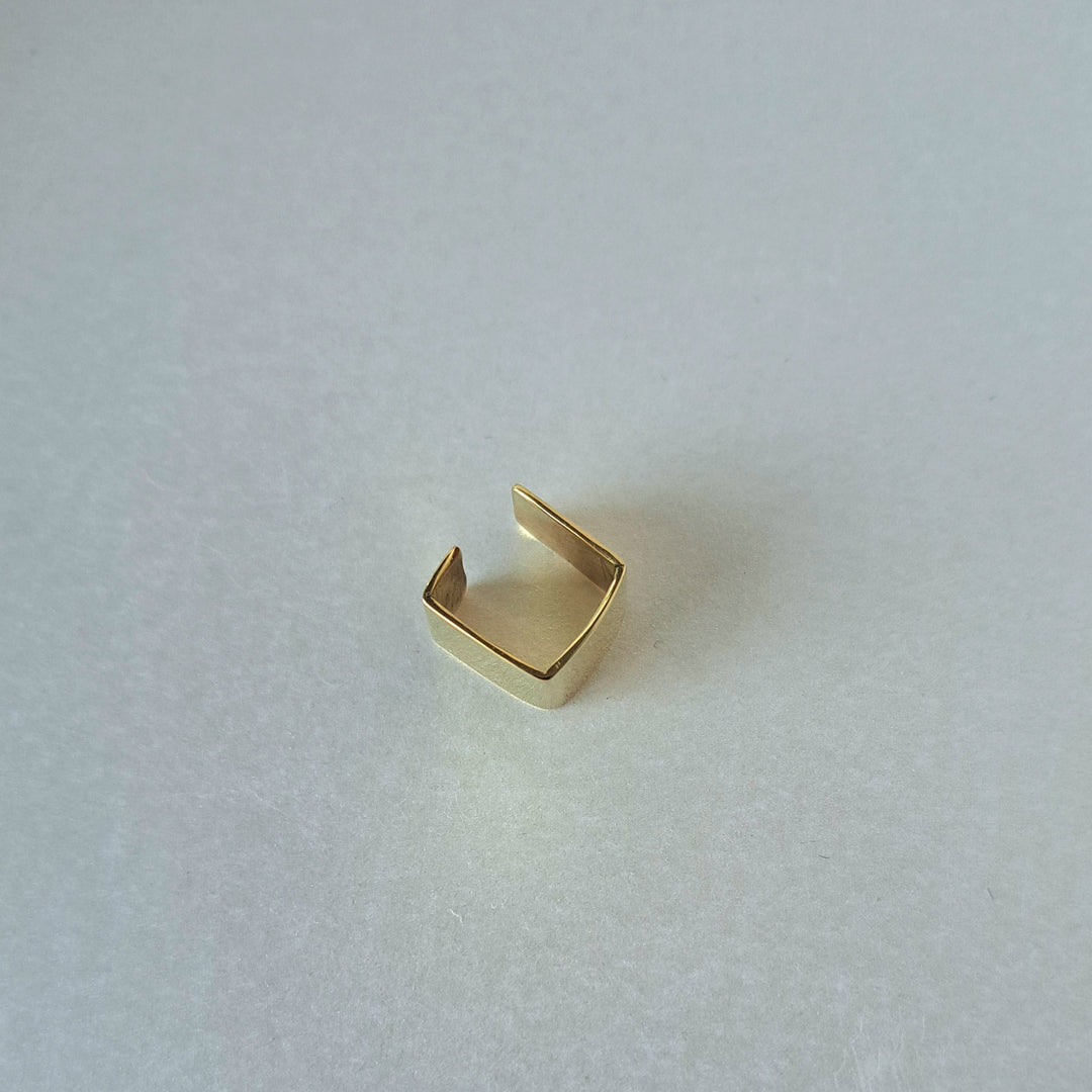 Gold ring on a textured white surface